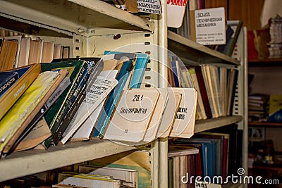 Moscow, Russia - January 2015: Abandoned factory library, old Soviet books on shelves Editorial Stock Photo