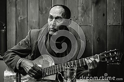 Moscow, Russia January 31, 2021 photo of a bard at a meeting of bards playing in one of the local clubs Editorial Stock Photo