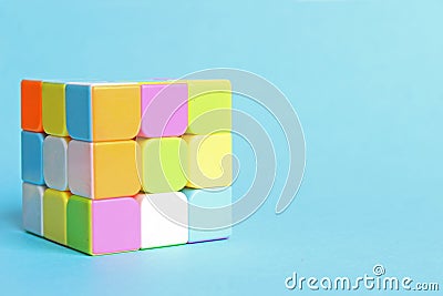 Moscow. Russia. 17 January 2020. Rubik's cube on a blue background. Gentle colors. Toys for children. Puzzles Editorial Stock Photo