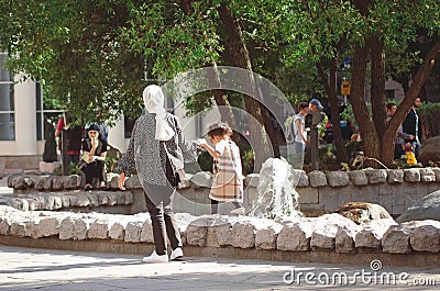 Chistoprudny Boulevard in Moscow. Mom and daughter are walking near the fountain. Editorial Stock Photo