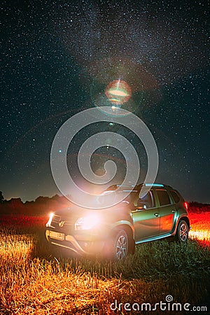 Night Starry Sky With Glowing Stars Above Renault Duster SUV Car In Countryside Landscape. Milky Way Galaxy And Rural Editorial Stock Photo