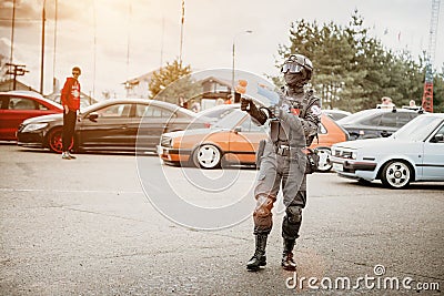 Moscow, Russia - July 06, 2019: special forces soldier guards cars. Cosplay anime fighter with fake weapons and a water pistol. Editorial Stock Photo