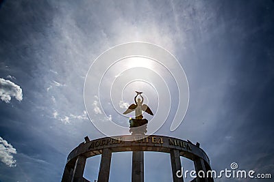 Statue of an angel and the sun above it Editorial Stock Photo