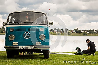 Moscow, Russia - July 13, 2019: Volkswagen T1 transporter restored retro car on the lake. Man resting in nature Editorial Stock Photo