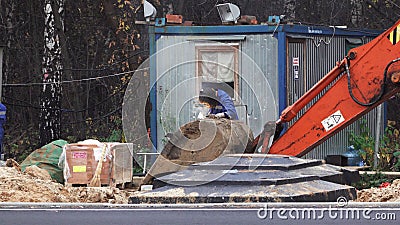 MOSCOW, RUSSIA - JULY 13, 2018: workers, welders made by electric welding excavator bucket Editorial Stock Photo