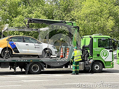 Moscow, Russia, June, 01, 2022. Carsharing car `Yandex Drive` was loaded onto a tow truck on the street of the Soviet Army in Mosc Editorial Stock Photo