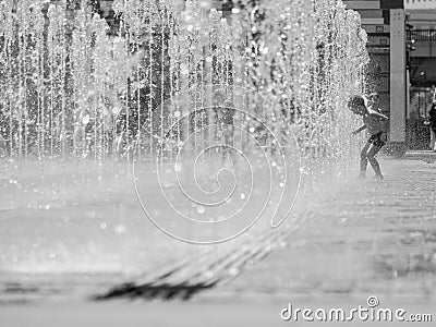 Moscow. Russia. June 19, 2019. Children bathing in a refreshing spray of the city fountain on a hot summer day Editorial Stock Photo