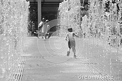 Moscow. Russia. June 19, 2019. Children bathing in a refreshing spray of the city fountain on a hot summer day Editorial Stock Photo