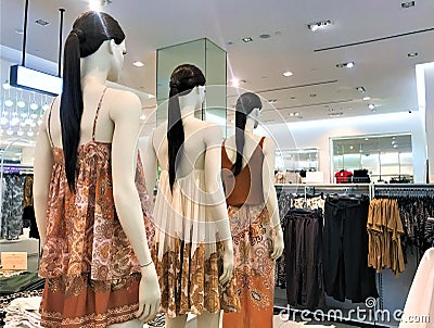 Moscow, Russia, June 2019: Female mannequins, brunettes with long hair and pony tail stand in line, one behind the other, dressed Editorial Stock Photo