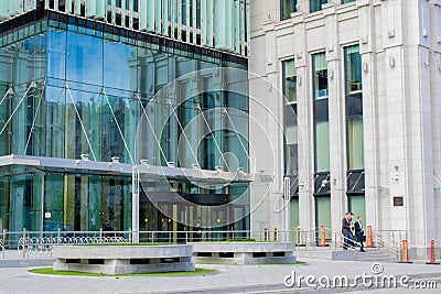 Glass entrance to a modern office building, white collars are going out Editorial Stock Photo