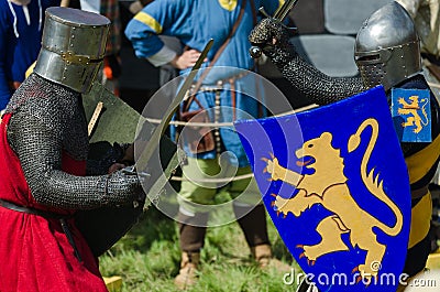 MOSCOW,RUSSIA-June 06,2016: Medieval warriors fight on duel. Knights struggle in armour with swords and shields in there hands Editorial Stock Photo