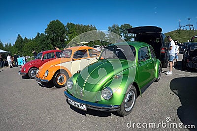 Moscow, Russia - June 01, 2019: Volkswagen beetle Kaefer parked in row on the open parking on the street. Green, orange and red Editorial Stock Photo