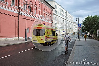 Yellow State Ambulance quickly moves to help the patient Editorial Stock Photo