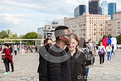 Young interracial couple of students in the city square in the summer . Editorial Stock Photo