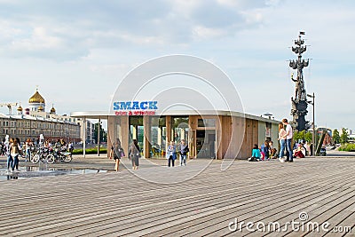 MOSCOW, RUSSIA - JUNE 14, 2016: Young people kiss in the background of a cafe SMACK Editorial Stock Photo