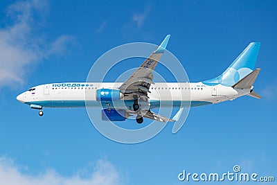 Moscow, Russia - March 26, 2019: Aircraft Boeing 737-81DWL VQ-BTE of Pobeda airline against blue sky in sunny morning going to Editorial Stock Photo