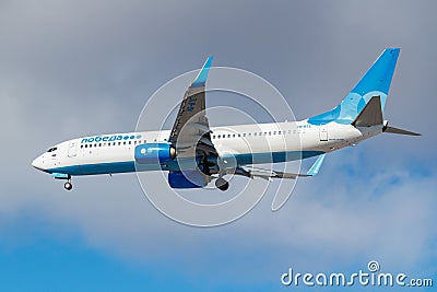 Moscow, Russia - March 26, 2019: Aircraft Boeing 737-81DWL VQ-BTE of Pobeda airline against blue sky in sunny morning going to Editorial Stock Photo