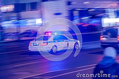 MOSCOW, RUSSIA - MARCH 12, 2018: The blurry silhouette of the speeding police car DPS traffic police with flashing lights and a Editorial Stock Photo