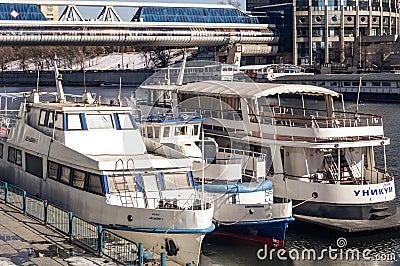 Pleasure boats are parked along the embankment on the Moscow River. Motor ships near Presnenskaya embankment Editorial Stock Photo