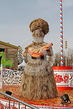 Straw Shrovetide doll with bird at Russian national festival `Shrove` in the park VDNKh in Moscow Editorial Stock Photo