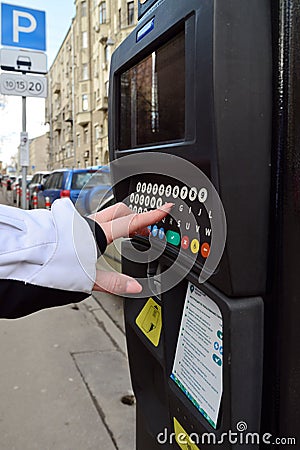 Moscow, Russia - March 14, 2016. Woman's hand enters the data in parking payment machine Editorial Stock Photo