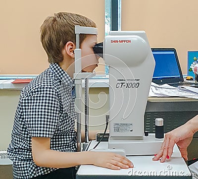 Moscow, Russia - May 20, 2019: A boy at an appointment with an ophthalmologist checks vision on the device. Child health Editorial Stock Photo