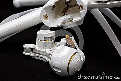 Moscow, Russia - May 13, 2019: Broken white Xiaomi Mi drone 4k after a fall. On a black background. Damaged body and stabilizer Editorial Stock Photo