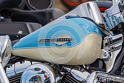 Moscow, Russia - May 04, 2019: Glossy blue fuel tank with Harley Davidson motorcycles emblem and chromed engine closeup. Moto Editorial Stock Photo