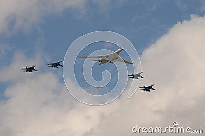 A group of SU-35S fighters and a Tu-160 supersonic long-range strategic bomber fly over Moscow`s Red Square during the dress rehea Stock Photo