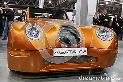 Moscow, Russia - May 25, 2019: Homemade and exclusive vintage retro car Agata 08 in gold color stands in the showroom. Ugly design Editorial Stock Photo