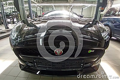 Moscow, Russia - May 1, 2019: Interior of Black Jaguar F-Type R on a lift at a Land Rover service center. Repair and diagnostics Editorial Stock Photo