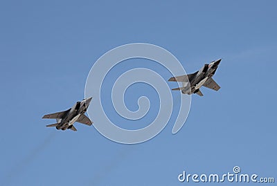 The modernized fighter-interceptor MiG-31 with hypersonic missiles `Dagger` flying in the sky over red square. Editorial Stock Photo