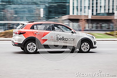 Moscow carsharing Belka Car. Kia Rio hatchback driving along the street on high speed. Car rental concept Editorial Stock Photo