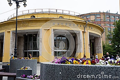 Moscow, Russia, may 25, 2019: round yellow building of Novokuznetsk metro station in the foreground flowerbeds with bright Editorial Stock Photo