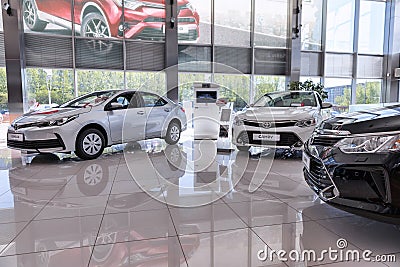 Selling cars Toyota in the showroom. New products automaker Toyota Editorial Stock Photo