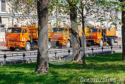 Moscow, Russia - May 01, 2019: Three large orange sprinkler trucks with plastic water tanks parked on Moscow street in sunny Editorial Stock Photo