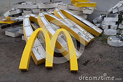 Moscow, Russia - 06.21.2022: McDonalds logo letter character M on dirty rubbish heap dump trash litter garbage. Fast Editorial Stock Photo