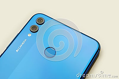 Moscow, Russia - 22 October 2019: Dual camera, backlight and fingerprint scan on the phone. Honor 8x smartphone detail Editorial Stock Photo