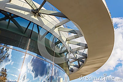 Moscow, Russia - October 08, 2019: Facade of contemporary building with curved glasses in sunny day. Blue sky with white clouds Editorial Stock Photo