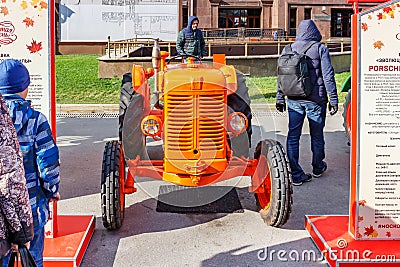 Moscow, Russia - October 08, 2019: Front view of the restored vintage orange italian wheel tractor FIAT 25. Traditional festival Editorial Stock Photo