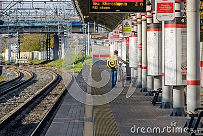 Moscow. Russia. October 4, 2020 A young girl and a guy with bicycles stand on the platform of a railway station Editorial Stock Photo