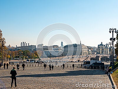 Moscow, Russia - October 5, 2021: View of the Moskvoretsky bridge and the architecture of the capital. People walk along the red Editorial Stock Photo