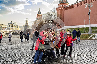 Moscow, Russia. Red Square, autumn. Cheerful tourists and travelers are photographed for a good mood. Editorial Stock Photo