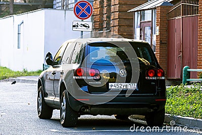 car Volkswagen Touareg 7L in black body color. Rear view of old Touareg parked on city street in sunlight Editorial Stock Photo