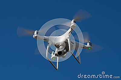 MOSCOW, RUSSIA - 24 September, 2017: DJI Phantom 4 pro quadcopter drone flying with a camera against blue sky. Editorial Stock Photo