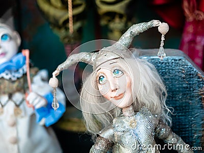 Dolls depicting fairytale heroes in a window of a Moscow Puppet Theater. The figure of a Jester or harlequin with blue eyes in hat Editorial Stock Photo