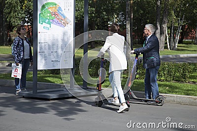 MoscowRussia, September 3, 2020 An elderly couple rides an electric scooter Editorial Stock Photo