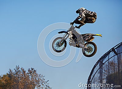 Moscow / Russia - September 23 2017: Pro motocross rider riding fmx motorbike, jumping performing extreme stunt. Professional Editorial Stock Photo