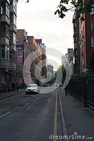 MOSCOW / RUSSIA - 20/04/2019 vertical shot of the Stolyarnyy Pereulok Street with its buildings, facades, fences cars and walking Editorial Stock Photo