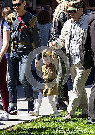 Victory Day in Moscow. Cute little Asian girl in military uniform on Victory Day. Editorial Stock Photo